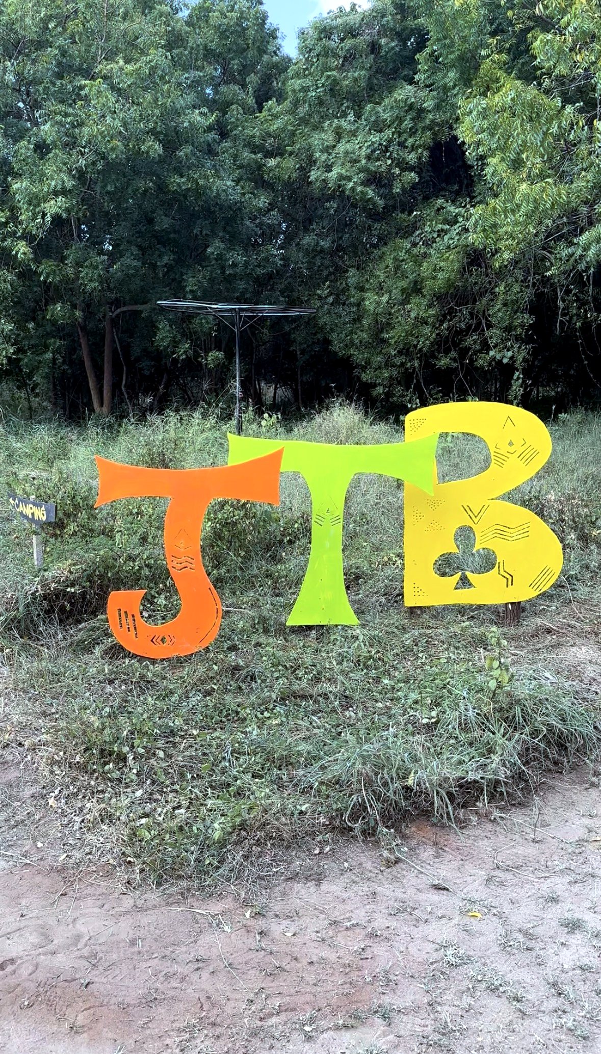 Sculptural festival signage set among the trees at Beneath the Baobabs