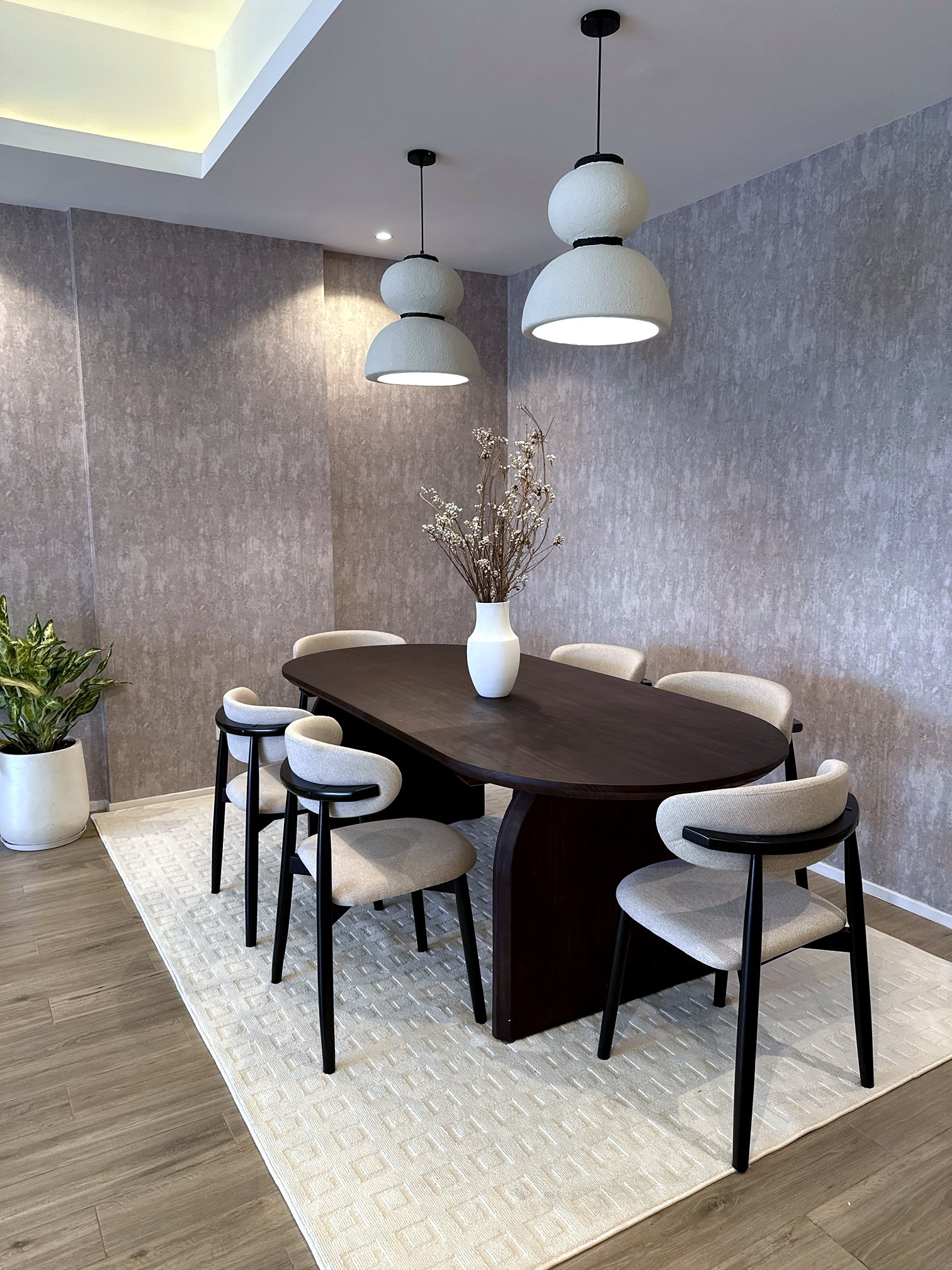 A dining nook with paired ceramic pendant lights